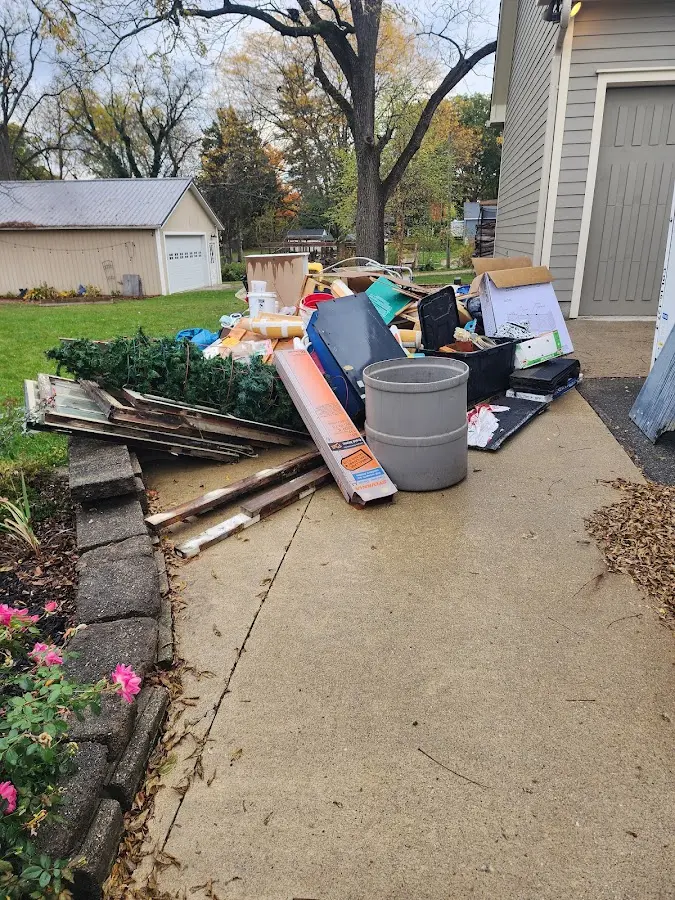 Dumpster being loaded with debris for Roofing Dumpster Rental in Burr Ridge